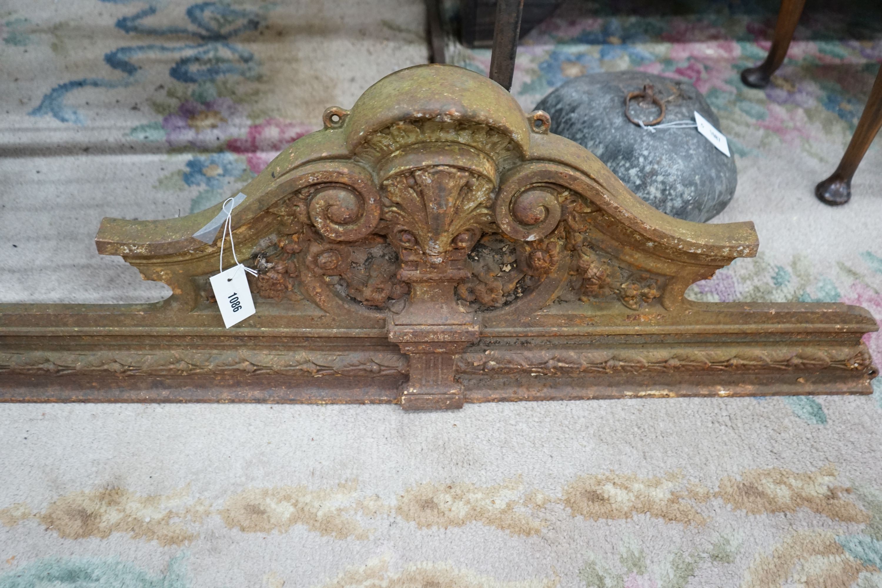 A pair of Victorian cast iron shell and scroll door pediments, each width 108cm, height 38cm